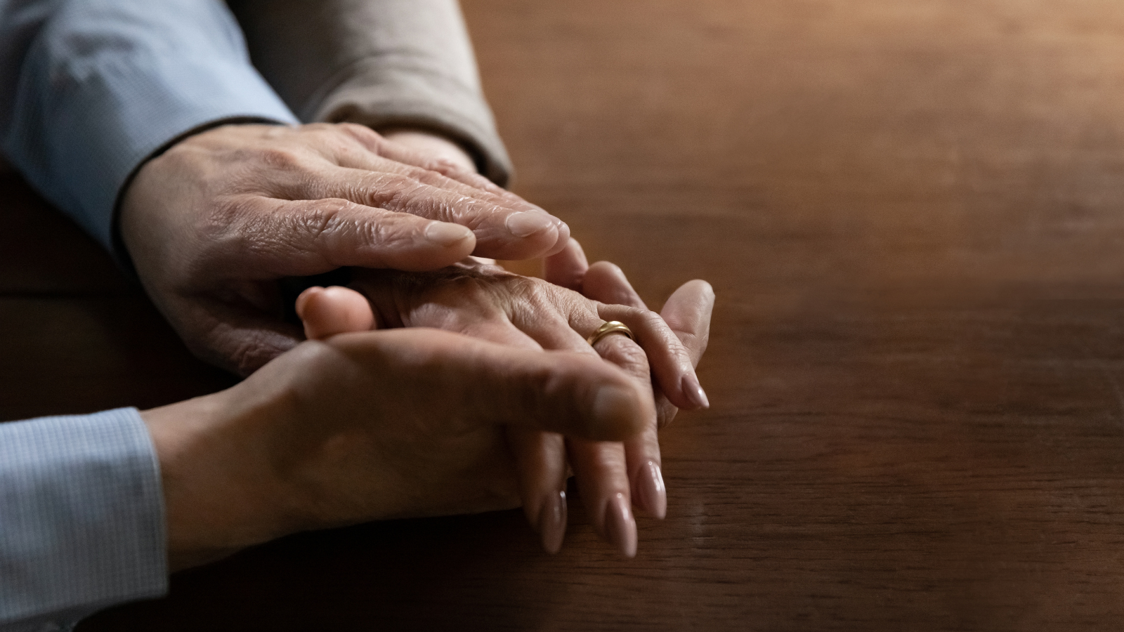 Senior mature man holding hand of beloved middle aged wife.couple enjoys time together, expressing love, affection and support.